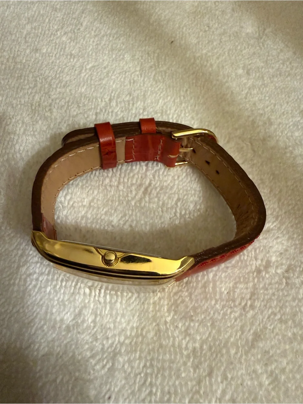 Clarins Gold-Tone Rectangular Watch with Red Strap and White Dial